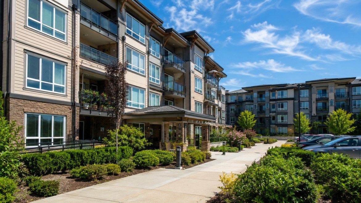 Condominium Home Association Building With Shared Entrance, Parking, And Landscaped Common Areas